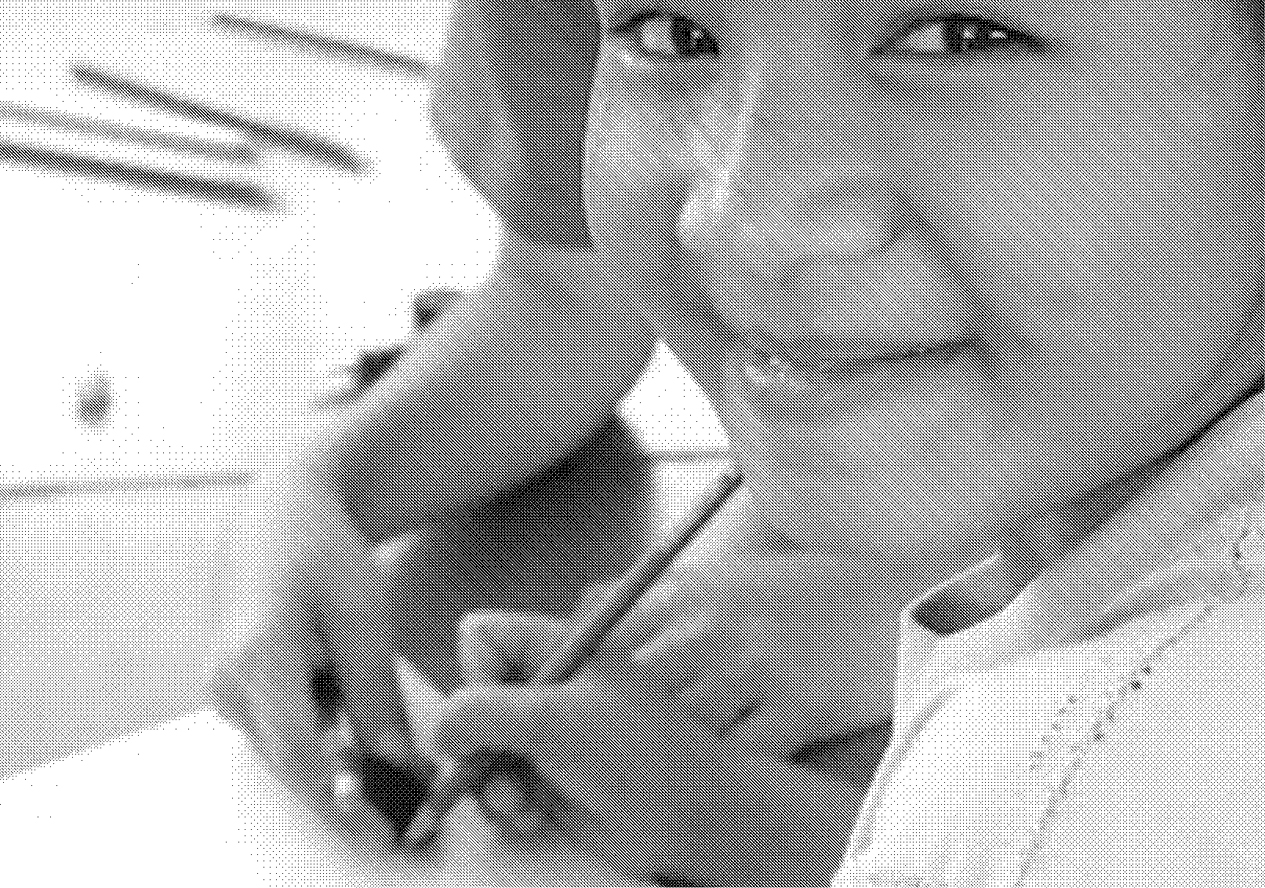 a child with a colouring pencil smiles at the camera.