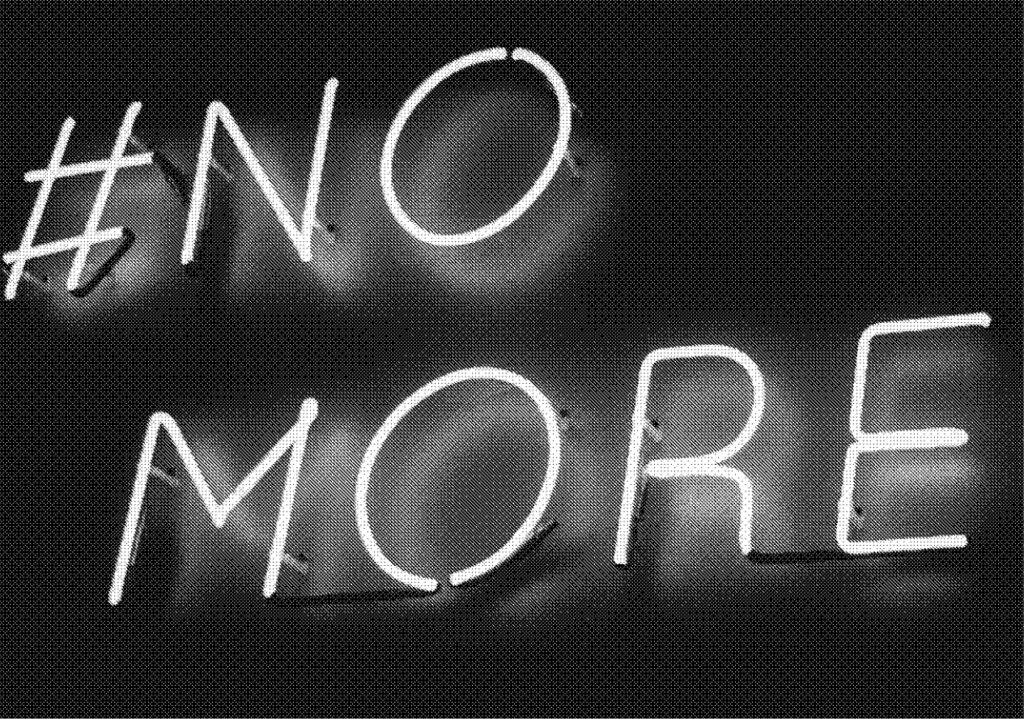 greyscale image of a neon sign saying #NoMore