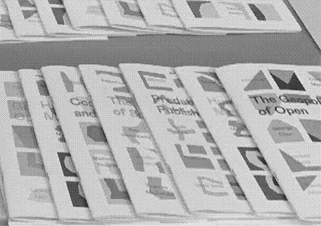 greyscale image of zines on a table