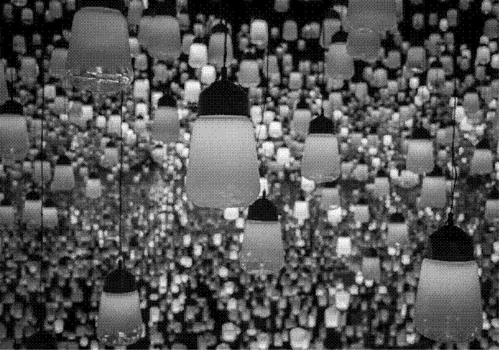 greyscale image of thousands of lamps hanging down