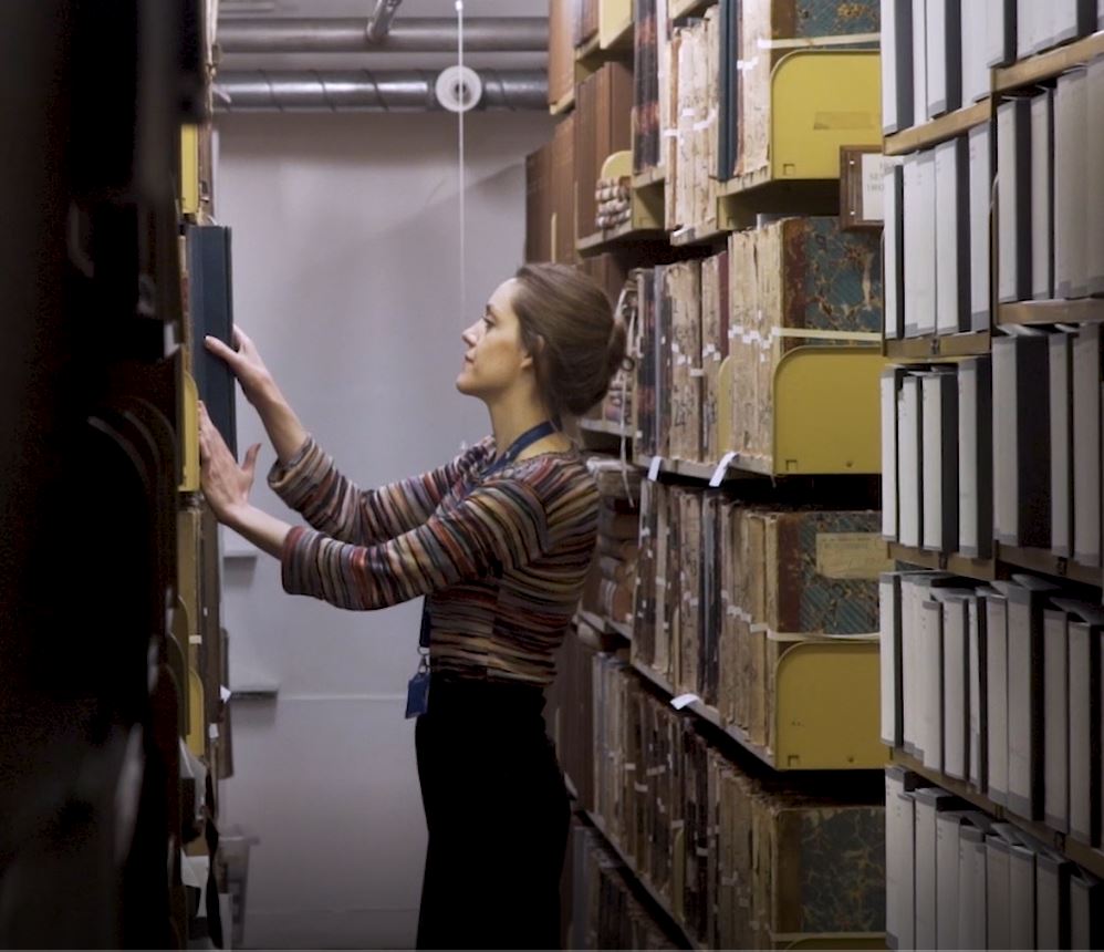 image of a library worker in library stacks